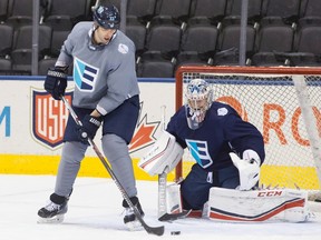 Team Europe's Zdeno Chara (left) tries to deflect a puck on net in front of goaltender Philipp Grubauer during a practice session at the World Cup of Hockey in Toronto on Friday, Sept. 23, 2016. (Chris Young/The Canadian Press)