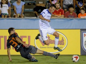 FC Edmonton midfielder Ben Fisk, right avoids a challenge from Carolina RailHawks defender Steve Miller, in a North American Soccer League game Saturday, Sept. 24, 2016, at WakeMed Soccer Park in Cary, North Carolina. The RailHawks won the game 1-0.