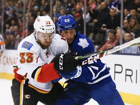 Brooks Laich #23 of the Toronto Maple Leafs tangles with Jakub Nakladal #33 of the Calgary Flames ,. as the Calgary Flames take on the Toronto Maple Leafs at the Air Canada Centre in Toronto on Monday March 21, 2016. Stan Behal/Toronto Sun/Postmedia Network