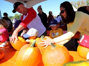 Seven-year-old Tiago and four-year-old Kai get some help from parents Luis Fernandes and Angie Pang to carve their pumpkins during the Flavours of Fall celebration on Saturday September 24, 2016 in Belleville, Ont. 

Emily Mountney-Lessard/Belleville Intelligencer/Postmedia Network