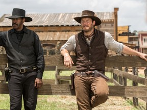 In this image released by Sony Pictures, Chris Pratt, right, and Denzel Washington appear in a scene from "The Magnificent Seven." Antoine Fuqua’s “The Magnificent Seven” remake rode the star power of Denzel Washington to an estimated $35 million debut, topping North American ticket sales over the weekend. (Sam Emerson/Sony Pictures via AP)