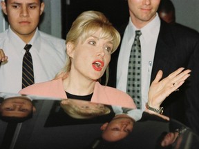 This file photo taken on Jan. 23, 1998 shows Gennifer Flowers (C) answering reporters' questions following her interview on CNN's Larry King Live show in Hollywood, Calif. (AFP PHOTO / MIKE NELSONMIKE NELSON/AFP/Getty Images)