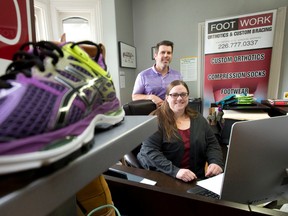 Footwork Orthotics owner Jeff Lewis finds office manager Lorna MacDougall has his back, especially since Lewis decided to make his Oxford Street specialty footwear shop a living wage employer. (CRAIG GLOVER, The London Free Press)