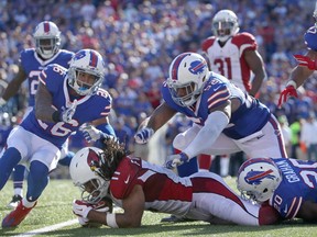 Larry Fitzgerald of the Arizona Cardinals is gang tackled by the Buffalo Bills during the second half at New Era Field on September 25, 2016 in Orchard Park, New York. (Tom Szczerbowski/Getty Images)