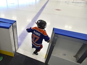 A tiny McDavid steps onto the ice after the grand opening of the Downtown Community Arena attached to Rogers Place in Edmonton, Sunday, September 25, 2016.