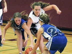 Mitchell's Hanna Jubinville (left), Stratford Northwestern's Julia Dixon and Mitchell's Dakota Baker battle for a loose ball in the fourth quarter of the Huron Perth junior girls basketball game Sept. 21 in Stratford. The Blue Devils dropped their season opener, 57-12. CORY SMITH POSTMEDIA NETWORK
