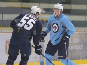 Winnipeg Jets forward Patrik Laine (r) and center Mark Scheifele go after the puck during NHL hockey practice in Winnipeg, Man. Monday September 26, 2016.
Brian Donogh/Winnipeg Sun/Postmedia Network