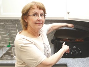 Vulcan Food Bank manager Brenda English lifts the lid to a turkey cooking as part of the Vulcan Food Bank/Family and Community Support Services (FCSS) turkey challenge. The challenge was offered to the Food Bank and FCSS clients, where they could pick up some new ideas of how to cook a turkey.