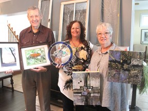 Barry Watson, left, Wendy White and Joan Belch, holding their own creations at White's home west of Kingston, are among the artists who will be showcasing their work at the annual Loyalist Studio Tour Oct. 1-2. (Michael Lea/The Whig-Standard)