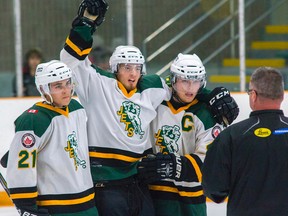 Cody Smith raises his arm to celebrate his overtime goal that gave the Amherstview Jets a 3-2 win over the Picton Pirates in a Provincial Junior Hockey League game Sunday night at W.J. Henderson Recreation Centre. Smith crashed hard into the boards after scoring the goal and was helped across the ice by teammates Joey Mayer, left, and Adam Alcorn, right. (Tim Gordanier/The Whig-Standard)