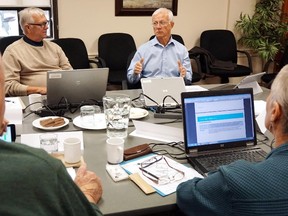 Luke Hendry/The Intelligencer
South East LHIN chief executive officer Paul Huras, background right, speaks to the board during a a meeting Monday in Belleville. From left are directors Jack Butt, Chris Salt and Maribeth Madgett.