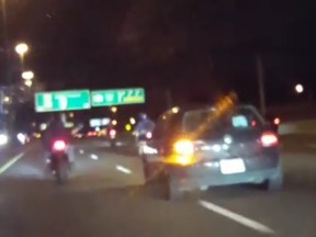 A Volkswagen Golf and motorcyclists are seen on Hwy. 401 in this screengrab from a video posted to Instagram.