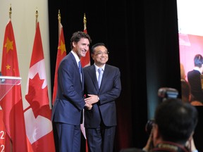 Canadian Prime Minister Justin Trudeau(L) and China Premier Li Keqiang embrace on September 23, 2016 at a conference of the Canada China Business Council in Montreal, Quebec. (Clément SABOURINCLEMENT SABOURIN/AFP/Getty Images)