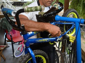 Shane Hodgson repairs one of the hundreds of bikes that will be given away at the Big Bike Giveaway on the Green in Wortley Village at 12 p.m. on Sunday. Hodgson, an avid cycler, and volunteers repair each bike before the giveaway. (MORRIS LAMONT, The London Free Press)