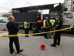 Police at the scene after hot tar coated a worker was when the driver of the truck braked at Danforth and Logan Aves. Monday, September 26, 2016. (Jack Boland/Toronto Sun)