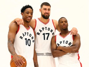 DeMar DeRozan, Jonas Valanciunas and Kyle Lowry pose for a photo during the opening day of Raptors training camp in Toronto on Sept. 26, 2016. (Dave Abel/Toronto Sun/Postmedia Network)