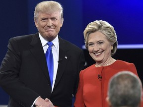 Democratic nominee Hillary Clinton (R) shakes hands with Republican nominee Donald Trump during the first presidential debate at Hofstra University in Hempstead, New York on Sept. 26, 2016. (PAUL J. RICHARDS/AFP/Getty Images)