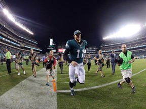 Philadelphia Eagles' Carson Wentz runs off the field after an NFL football game against the Pittsburgh Steelers on Sept. 25, 2016. (AP Photo/Michael Perez)