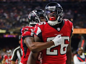 Atlanta Falcons running back Tevin Coleman crosses into the end zone for a touchdown in front of New Orleans Saints free safety Vonn Bell in the second half of a game on Sept. 26, 2016. (AP Photo/Butch Dill)