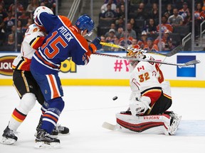 Tyler Pitlick (15) of the Edmonton Oilers takes a shot against goaltender Jon Gillies (32) of the Calgary Flames during a preseason NHL game on September 26, 2016 at Rogers Place in Edmonton, Alberta, Canada. Codie McLachlan/Getty Images