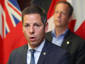 Winnipeg Mayor Brian Bowman (l) and city councillor John Orlikow speak about the new home development fee at a press conference earlier this month. (Brian Donogh/Winnipeg Sun file photo)