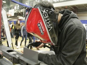 Daniel Little tries his hand at a welding simulator at Whitecourt’s Career and Education Expo at the Allan Jean and Millar Centre on Sept. 23 (Joseph Quigley | Whitecourt Star).