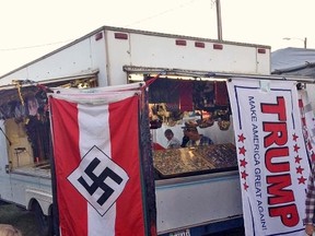 This photo provided by Edward Conner shows a Nazi flag displayed for purchase on a merchandise vendor's trailer Saturday, Sept. 24, 2016, at the Bloomsburg Fair fairgrounds in Bloomsburg, Pa. Bloomsburg Fair organizers shuttered the booth of Lawrence Betsinger, a vendor selling Nazi flags, on Monday, Sept. 26, 2016, after deeming some of his merchandise offensive. Betsinger pleaded guilty to child pornography charges in 2007. (Edward Conner via AP)