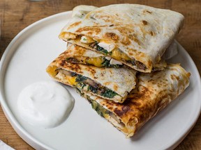 This August 2016 photo shows spinach, mushroom, and chicken quesadillas in New York. This dish is from a recipe by Katie Workman.