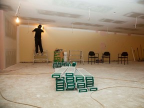 A worker sands down the drywall in the basement of the Vermilion Public Library on Friday, September 23, 2016, in Vermilion, Alta. The basement renovation is expected to be complete by Saturday, Oct. 1. Taylor Hermiston/Vermilion Standard/Postmedia Network.
