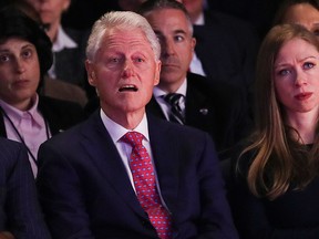 Former President Bill Clinton and Chelsea Clinton, daughter of Hillary Clinton listen during the presidential debate between Republican presidential nominee Donald Trump and Democratic presidential nominee Hillary Clinton at Hofstra University in Hempstead, N.Y., Monday, Sept. 26, 2016. (Joe Raedle/Pool via AP)