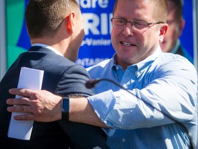 Andre Marin, right, is embraced by PC Leader Patrick Brown while announcing he's jumping into provincial politics as the Progressive Conservative candidate for Ottawa-Vanier Saturday September 24, 2016. (Ashley Fraser/Postmedia Network)