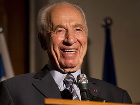This file photo taken on July 14, 2011 shows Israeli President Shimon Peres laughing as he addresses the annual Bastille Day reception at the French ambassador's residence in Tel Aviv. (JACK GUEZ/AFP/Getty Images)
