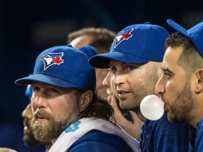 Toronto Blue Jays R.A. Dickey, J.A. Happ and Marco Estrada watch the team take on the Baltimore Orioles in Toronto on Sept. 27, 2016. (Craig Robertson/Toronto Sun/Postmedia Network)