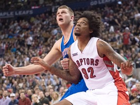 Toronto Raptors forward Lucas Nogueira battles for position under the hoop with New York Knicks centre Cole Aldrich during NBA action in Toronto on Dec. 21, 2014. (THE CANADIAN PRESS/Frank Gunn)