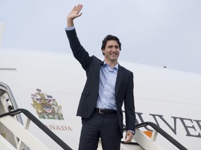Prime Minister Justin Trudeau boards a government plane before leaving the United Kingdom in this Nov. 26, 2015 file photo. (THE CANADIAN PRESS/Adrian Wyld)
