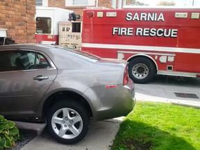 A car drove into the side of a building on Exmouth Street in Sarnia Tuesday afternoon, after it allegedly struck a pedestrian. The pedestrian wasn't injured and the driver has been charged with careless operation of a vehicle. Photo via Sarnia Fire Rescue's Twitter feed. ( Handout/Sarnia Observer/Postmedia Network)