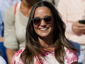 FILE- In this Friday, June 19, 2015 file photo, Pippa Middleton, left, the sister of Kate, the Duchess of Cambridge, watches the quarterfinal tennis match between Canada's Milos Raonic and France's Gilles Simon on the fifth day of the Queen's Championships in London. A British judge Wednesday Sept. 28, 2016 banned publication of stolen photographs of Pippa Middleton after allegations that 3,000 personal images were taken in a hacking attack on her iCloud account. (AP Photo/Tim Ireland, File)