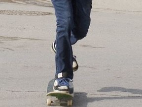 A skateboarder crosses a street in Ontario. (Postmedia Network files)