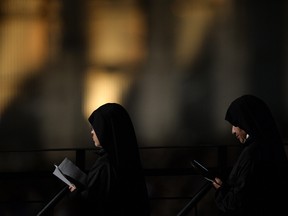 Nuns attend the Way of the Cross torchlight procession at the Colosseum on Good Friday on April 3, 2015 in Rome. (FILIPPO MONTEFORTE/AFP/Getty Images)