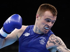 Ireland's Steven Donnelly, left, fights Algeria's Zohir Kedache during a men's welterweight 69-kg boxing match at the 2016 Summer Olympics in Rio de Janeiro, Brazil, Sunday, Aug. 7, 2016. (AP Photo/Frank Franklin II)