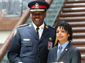 Toronto Police Chief Mark Saunders with son Graham at his swearing-in at police headquarters in Toronto on May 20, 2015. (Michael Peake/Toronto Sun)