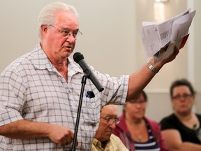 Tim Miller/The Intelligencer
Ken MacDonald, of Thurlow, holds up his Hyrdo One bill during a town hall meeting at the Gerry Masterson Community Centre in Thurlow on Wednesday. MacDonald was one of several residents upset with the rising costs of electricity.