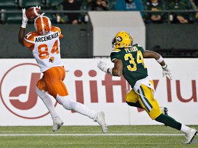 Garry Peters chases B.C. Lions' Many Arcenaux during Friday's game at Commonwealth Stadium. (The Canadian Press)