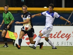 FC Edmonton midfielder Dustin Corea races Jacksonville Armada defender Bryan Burke to the ball during a game in Jacksonville, Fla., Wednesday. (James Drexler/Jacksonville Armada)