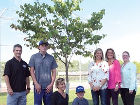 Tillsonburg Minor Hockey Inc. and Tillsonburg Minor Baseball Inc. joined together last week to dedicate a tree at the Kiwanis Ball Diamond in memory of Scott McLean, who was a dedicated coach and volunteer in both organizations. (CHRIS ABBOTT/TILLSONBURG NEWS)