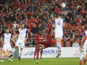 TFC’s Tosaint Ricketts misses on an overhead kick attempt and received his second yellow card for appearing to clip Orlando’s Jose Aja on the play. (THE CANADIAN PRESS)
