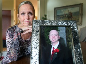 Judy Dunn sits with a photo of her son Andrew. Andrew died from suicide. (Brian Donogh/Winnipeg Sun)