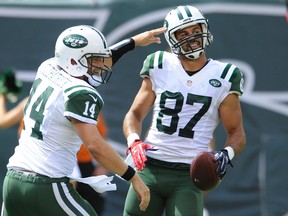Jets quarterback Ryan Fitzpatrick (14) and Eric Decker (87) celebrate after they connect for a touchdown during NFL action against the Bengals in East Rutherford, N.J., on Sept. 11, 2016. (Bill Kostroun/AP Photo)