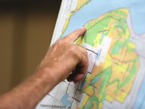 A resident points at a map during a public meeting about proposed changes to the Niagara Escarpment Plan. (James Masters The Sun Times)
