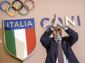 CONI (Italian Olympic Committee) President Giovanni Malago' applauds during a press conference at the CONI headquarters in Rome. The Rome city council Thursday, Sept. 29, 2016 has backed Mayor Virginia Raggi's decision to reject the capital's bid for the 2024 Olympics.(Giuseppe Lami/ANSA via AP Photo, File)